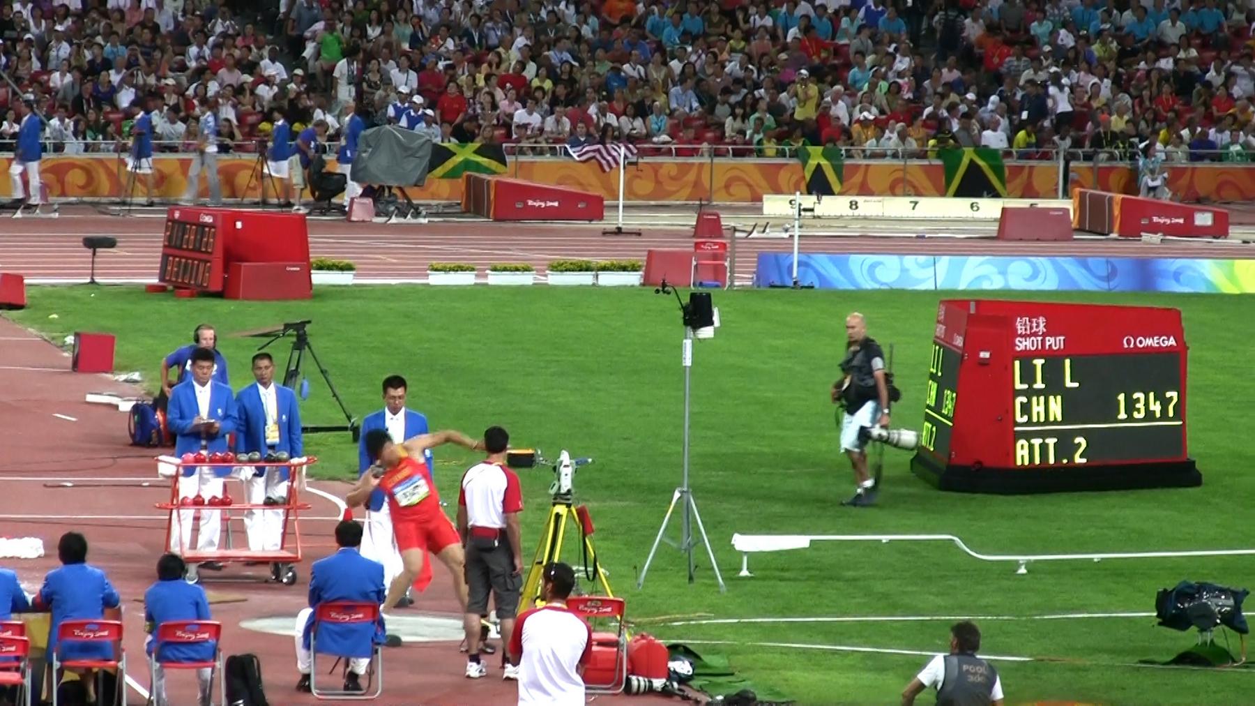 A shot put athlete throws during the Beijing 2008 Olympic Games.