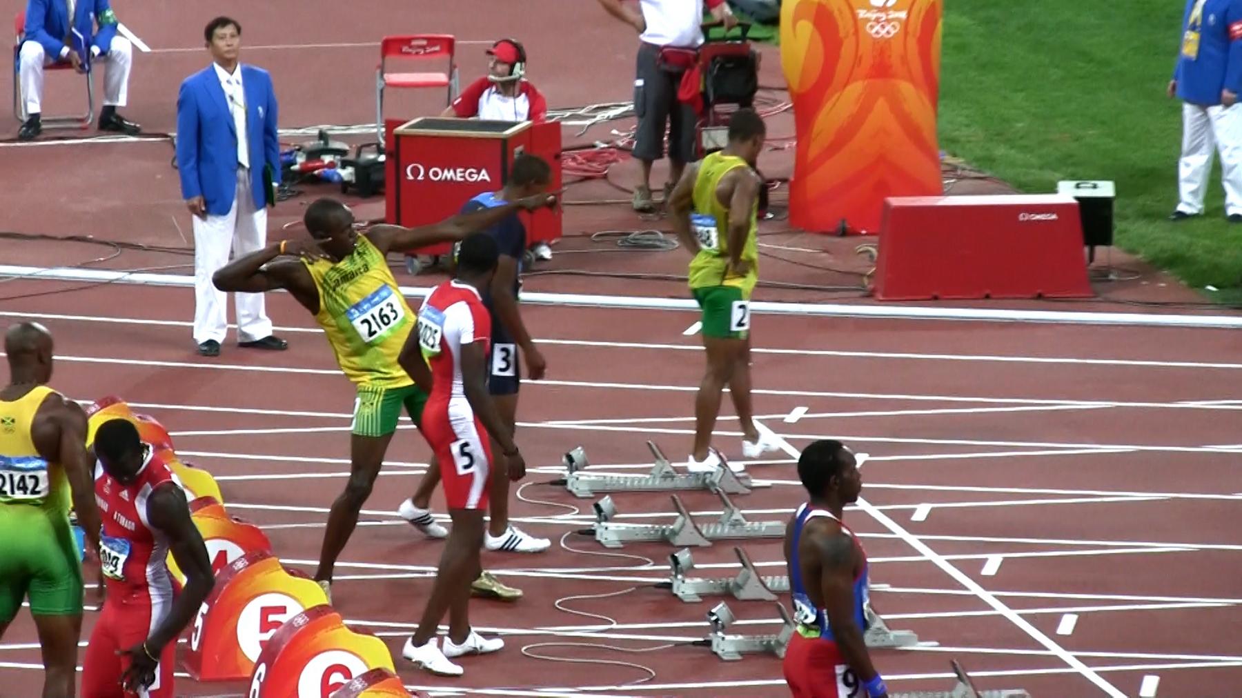 Usain Bolt strikes his signature pose on the running track at the Beijing 2008 Olympic Games.