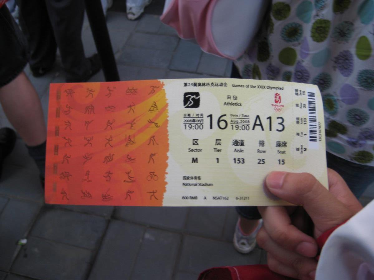 A hand holds a ticket for the Athletics event at the Beijing 2008 Olympic Games.