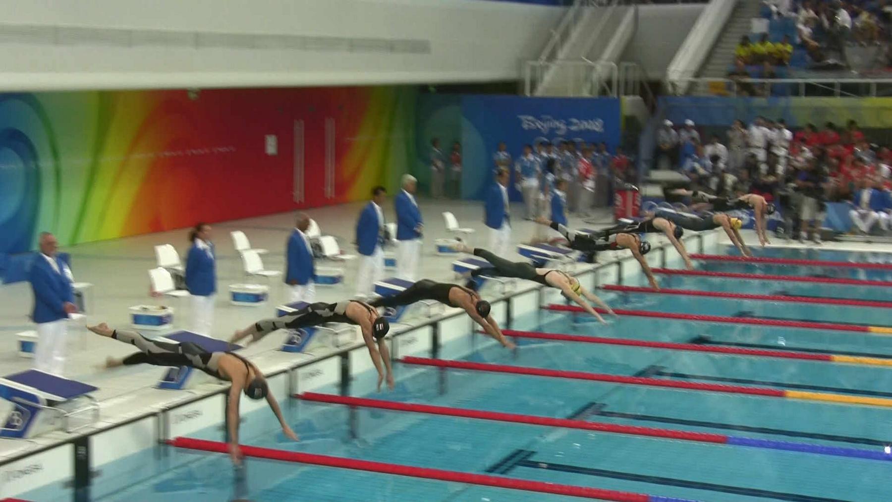 Swimmers diving into the pool at the Beijing 2008 Olympics.