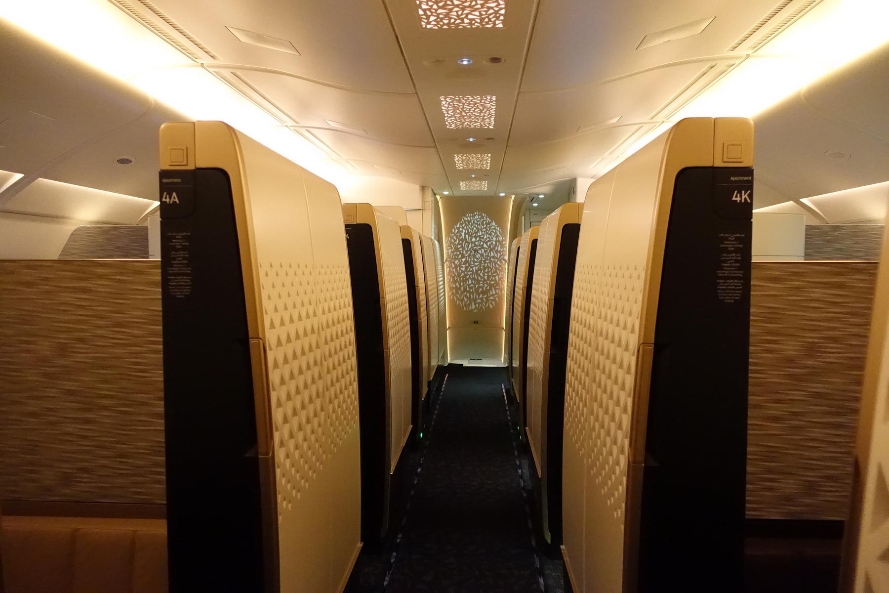The luxurious aisle of the Etihad A380 First Class cabin, lined with private suites.