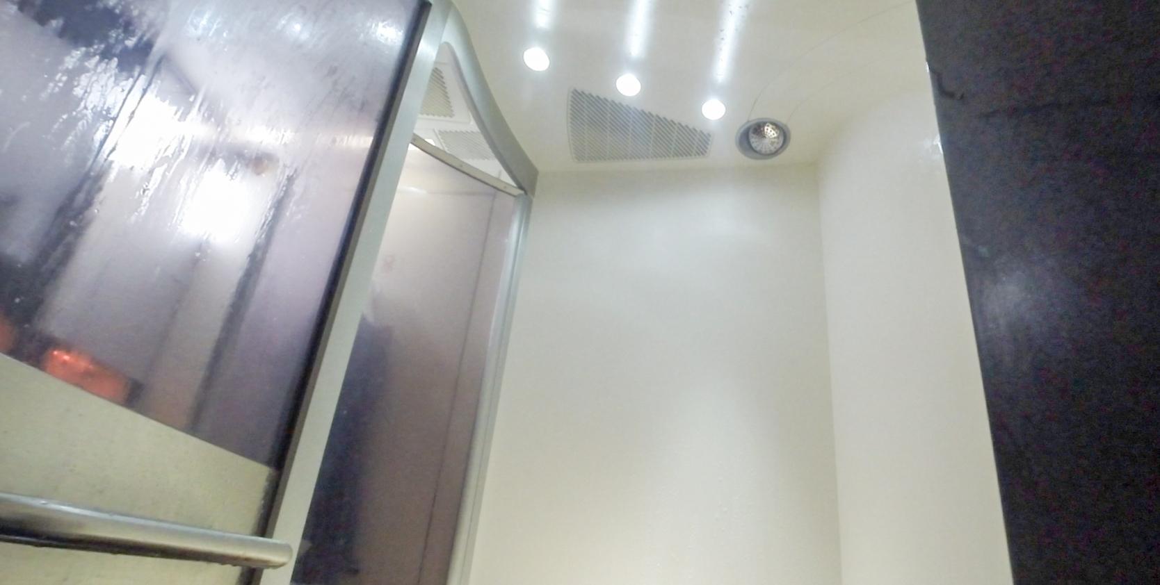 An onboard shower with a wet glass door on the Etihad A380 First Class.