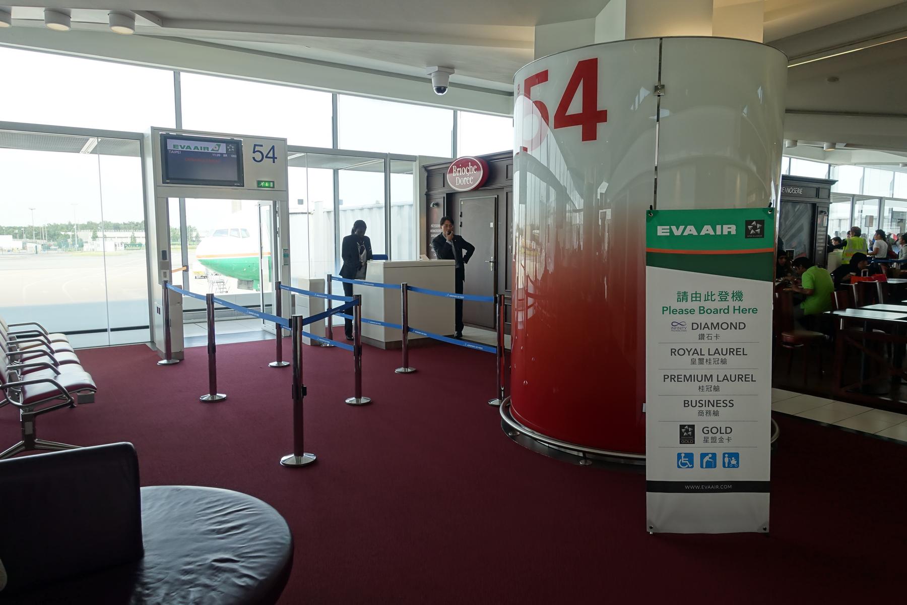 Eva Air boarding gate 54 with an airplane visible outside and a priority boarding sign.