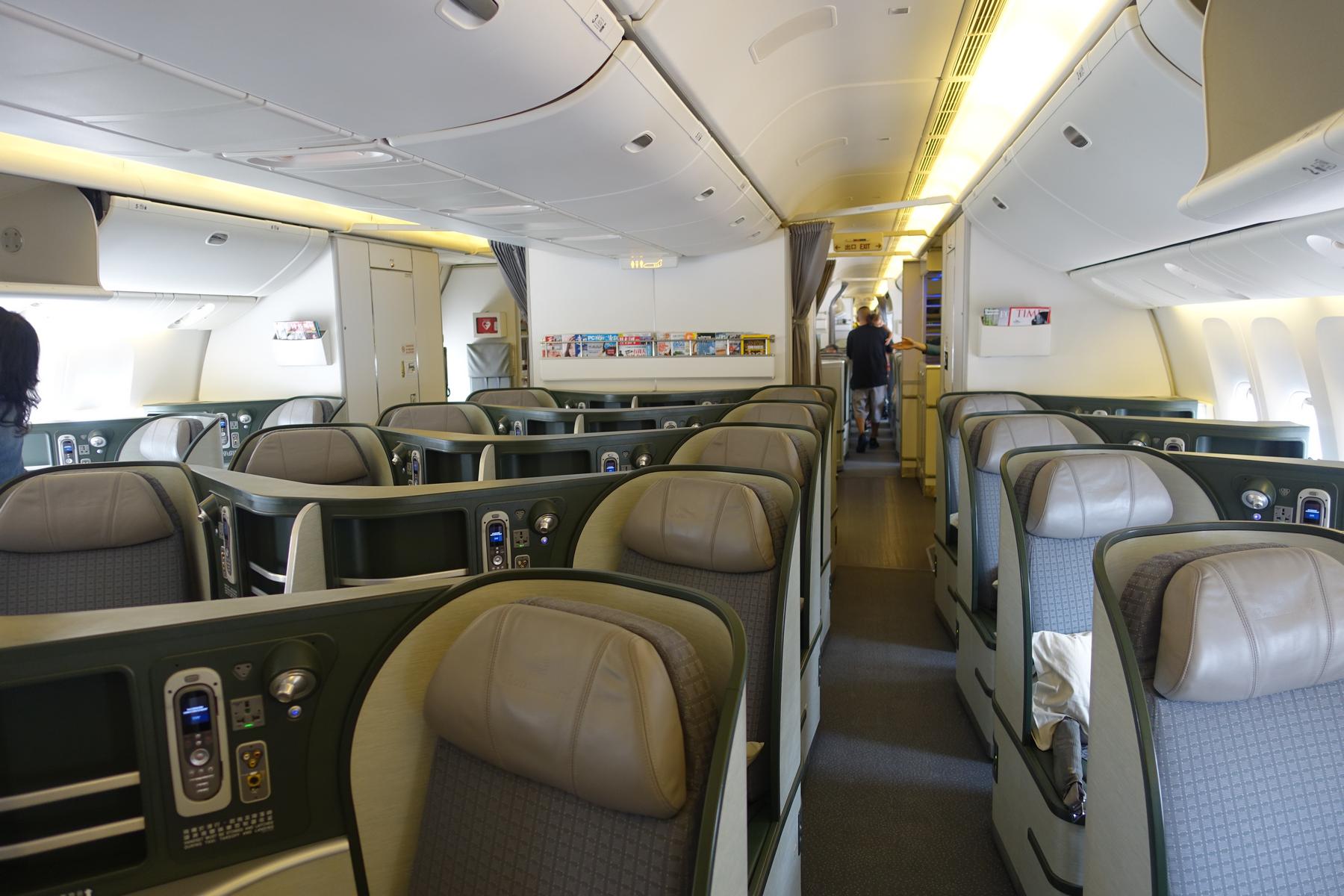 Interior of an Eva Air business class cabin with rows of spacious seats.
