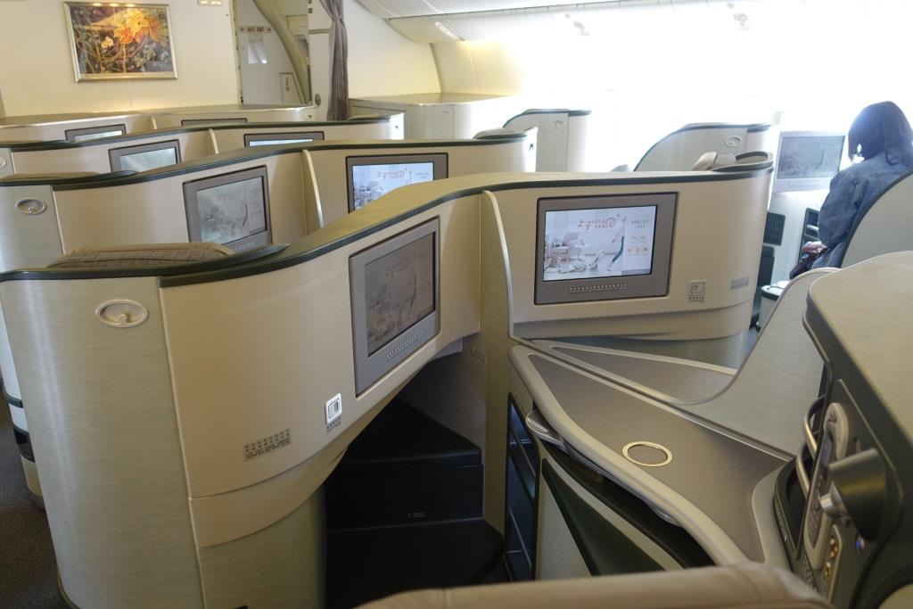 Eva Air business class cabin featuring private pods with entertainment screens.
