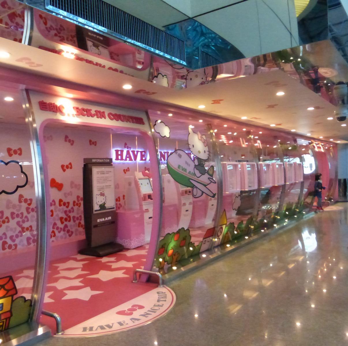 Pink, Hello Kitty themed Eva Air airport self-check-in area.
