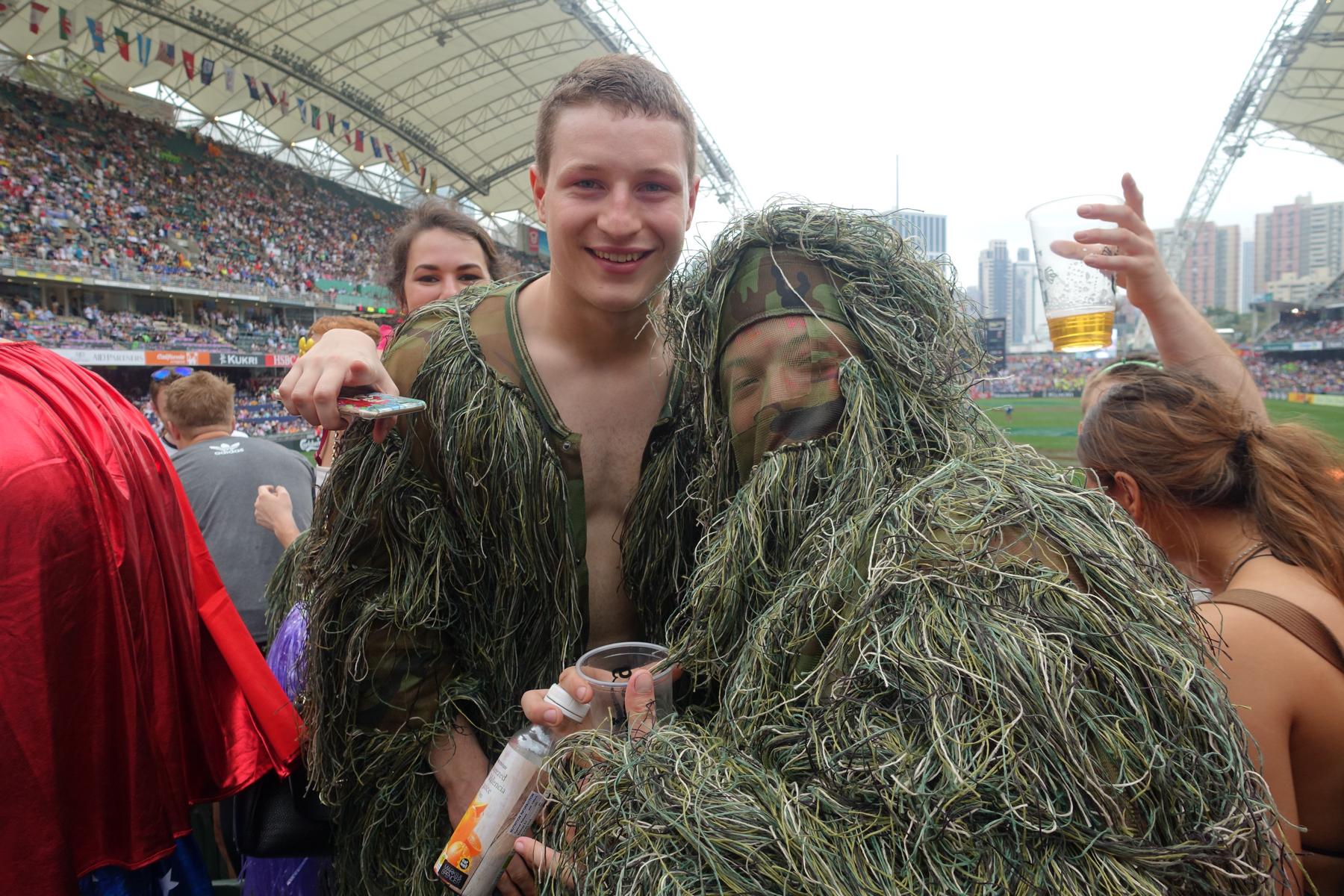 Fans dressed in ghillie suits smile for a photo at the Hong Kong Rugby Sevens.
