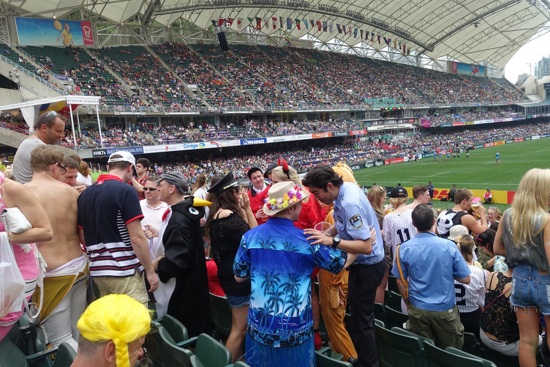A packed South Stand at the Hong Kong Rugby Sevens is filled with costumed spectators.