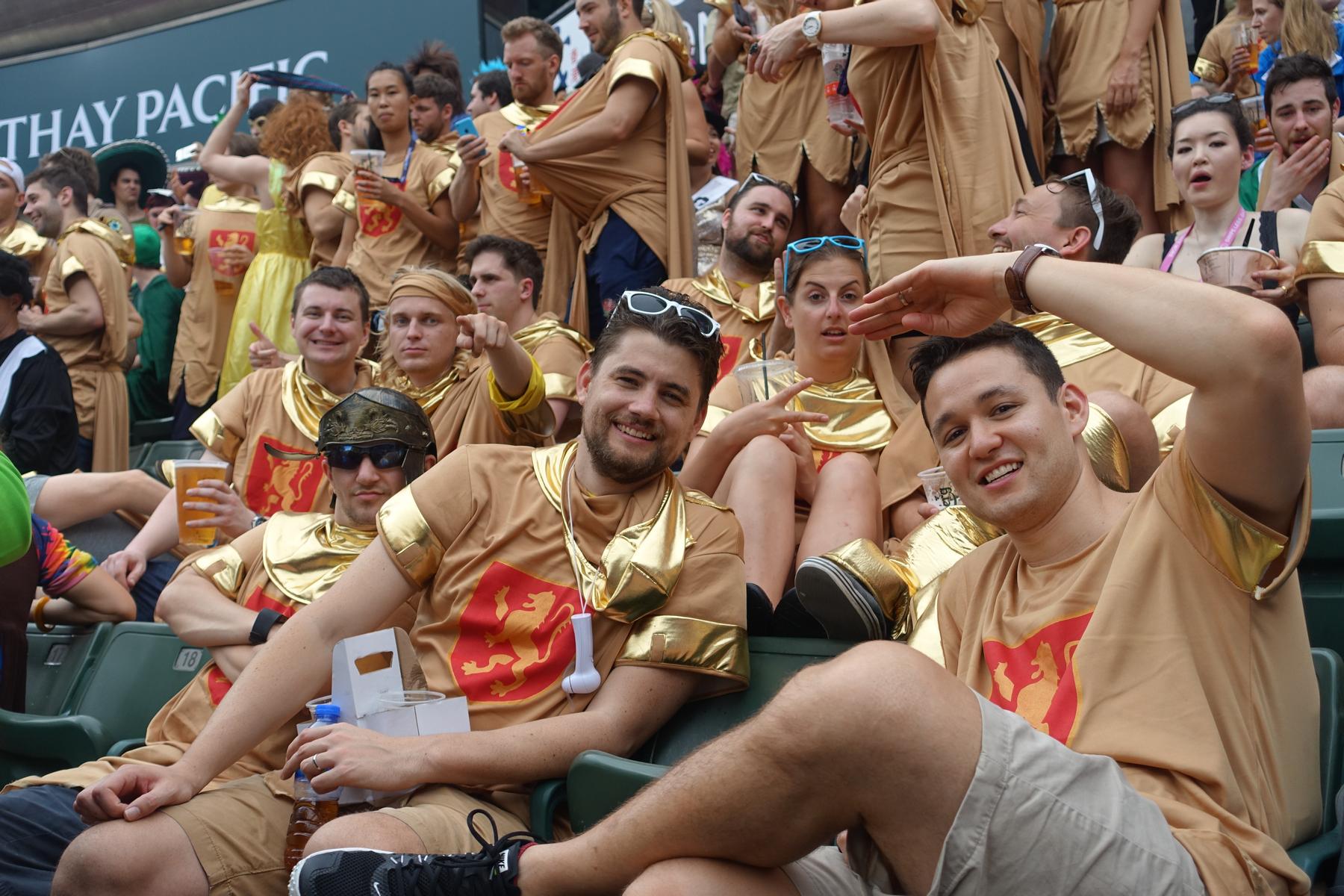 Festively dressed fans in lion-crested tunics pose for a photo in the South Stand at the Hong Kong Rugby Sevens.