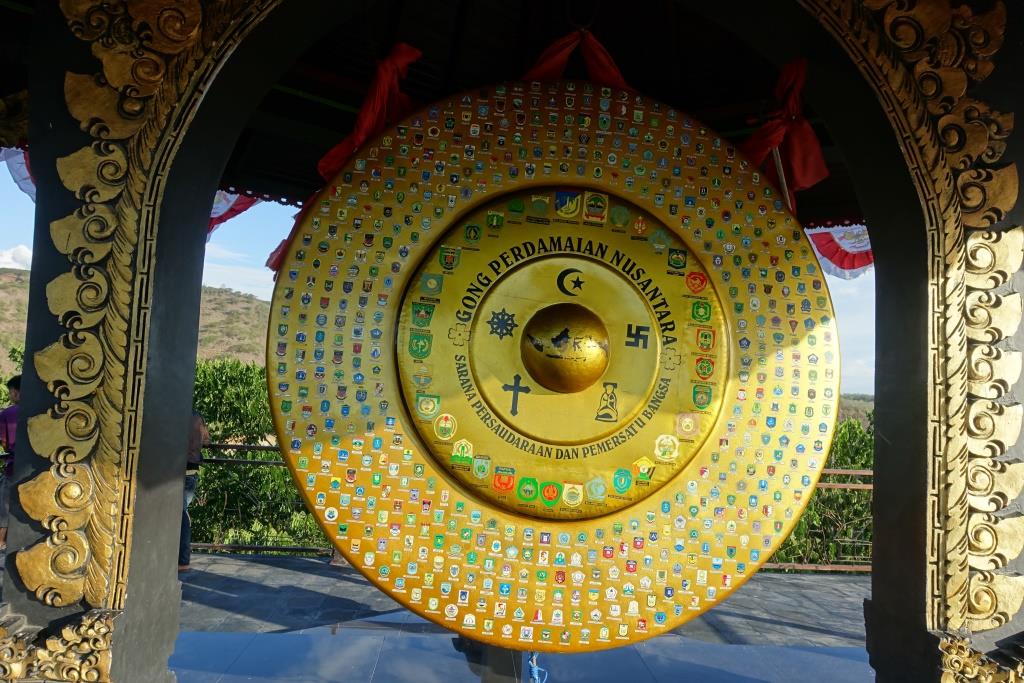 Golden Nusantara Peace Gong decorated with various religious symbols and regional emblems.