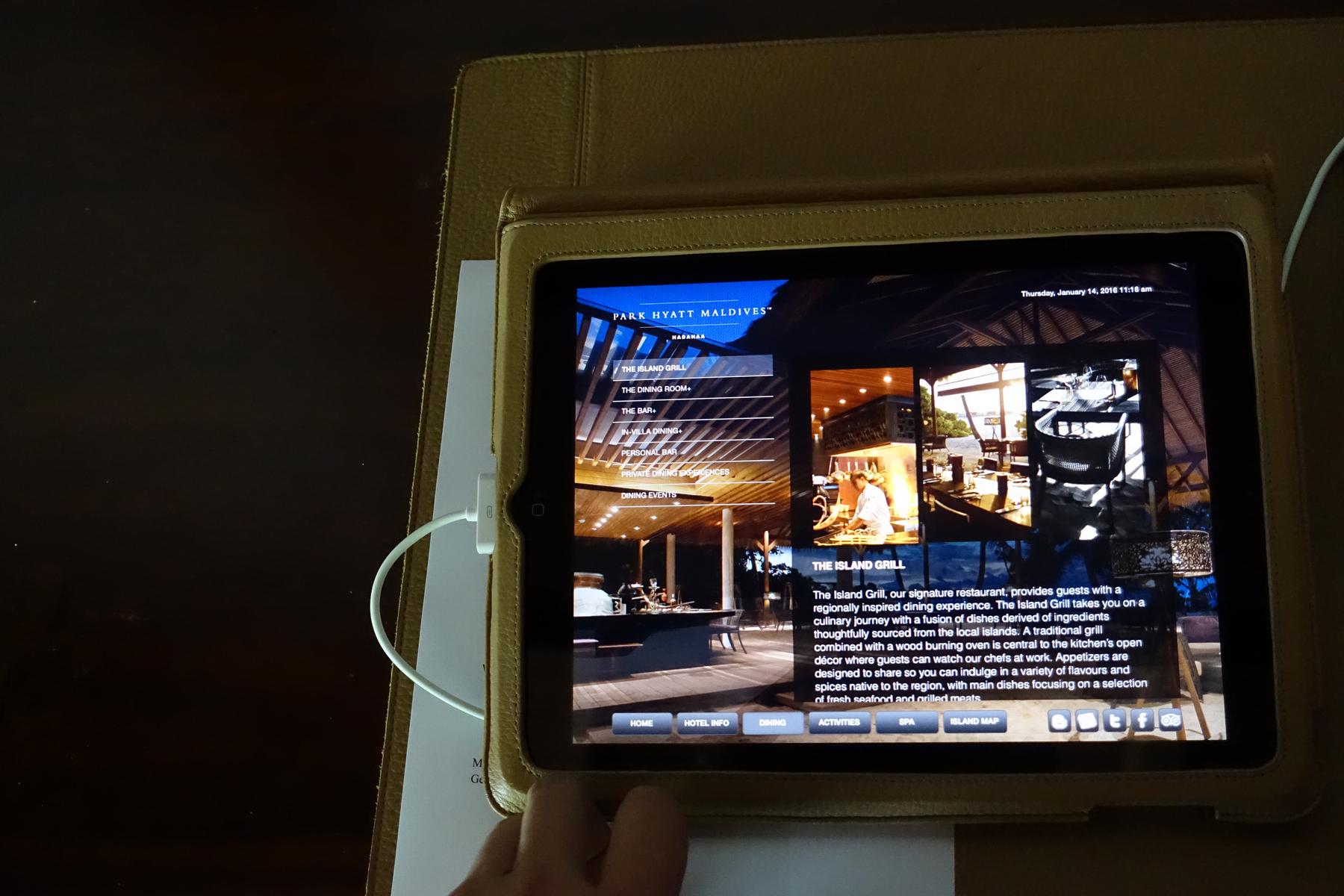 An iPad displays information about the Park Hyatt Maldives' The Island Grill restaurant.