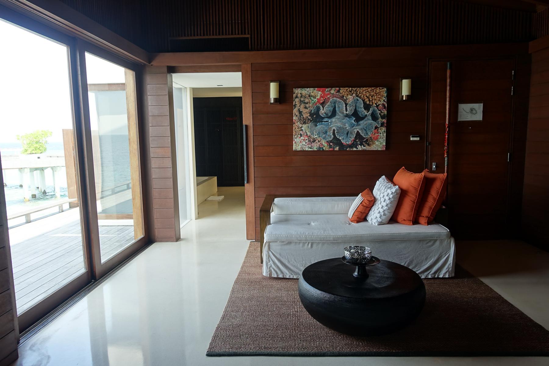 A stylish living area in a Park Hyatt Maldives water villa with an ocean view.