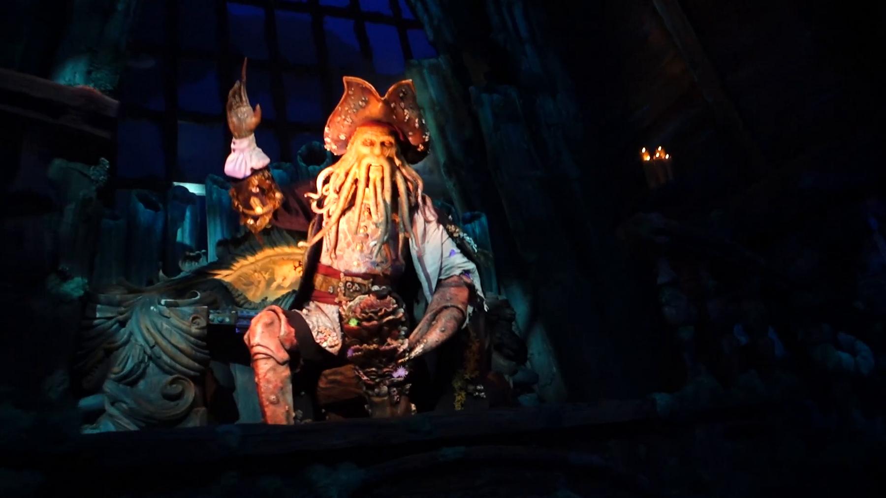 Davy Jones animatronic sits on a throne in a dark, underwater scene.