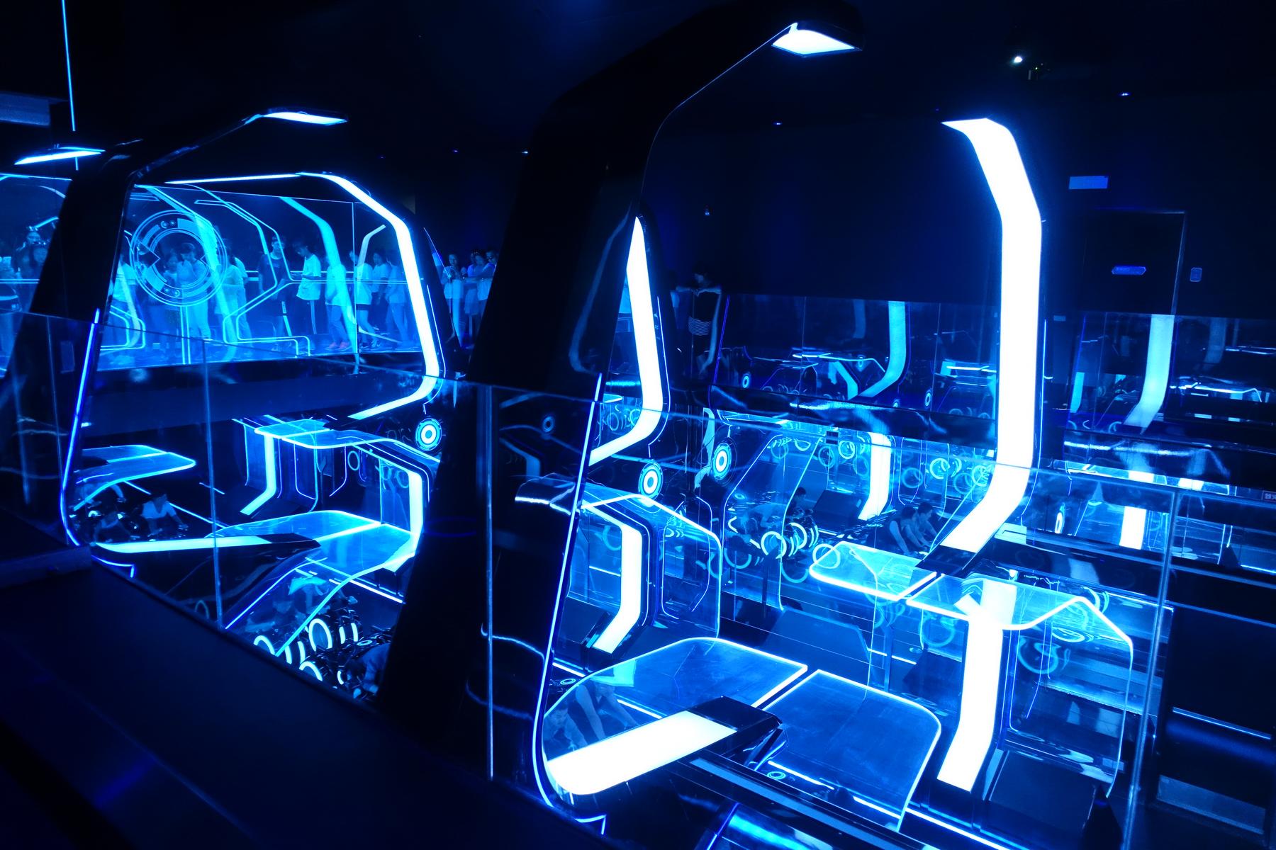Futuristic blue neon lights illuminate the Tron Lightcycle Power Run queue.