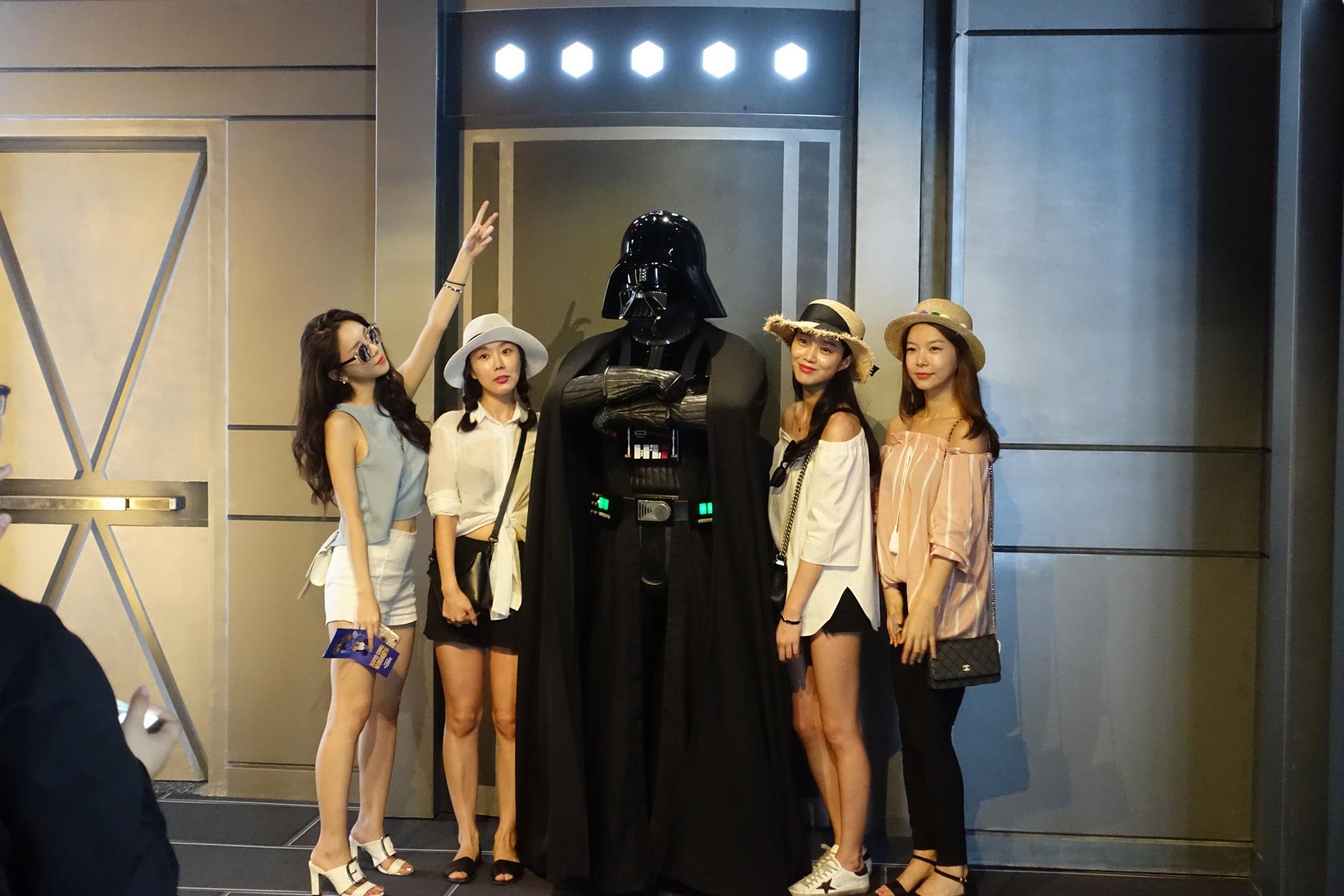 Four women pose with a Darth Vader character at Disneyland Shanghai.