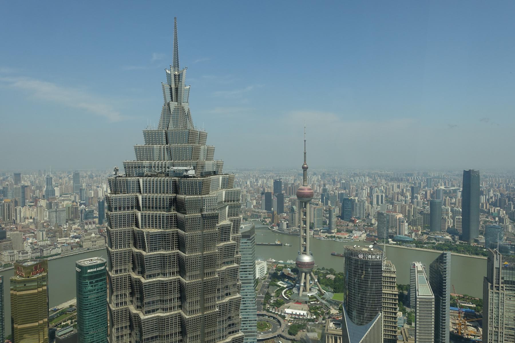 Panoramic view of Shanghai featuring the Jin Mao Tower and Oriental Pearl TV Tower.