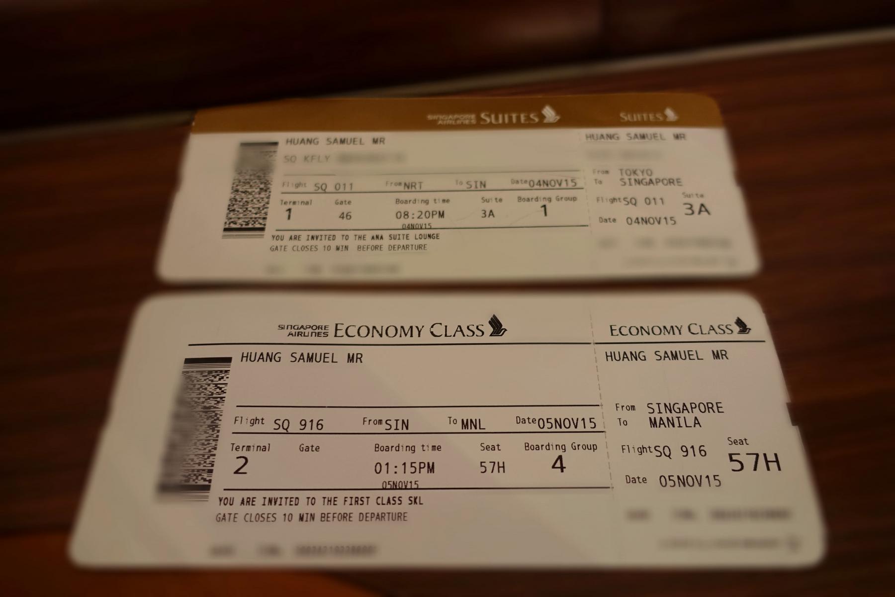 Two Singapore Airlines boarding passes are shown, one for Suites Class from Tokyo to Singapore and another for Economy Class.