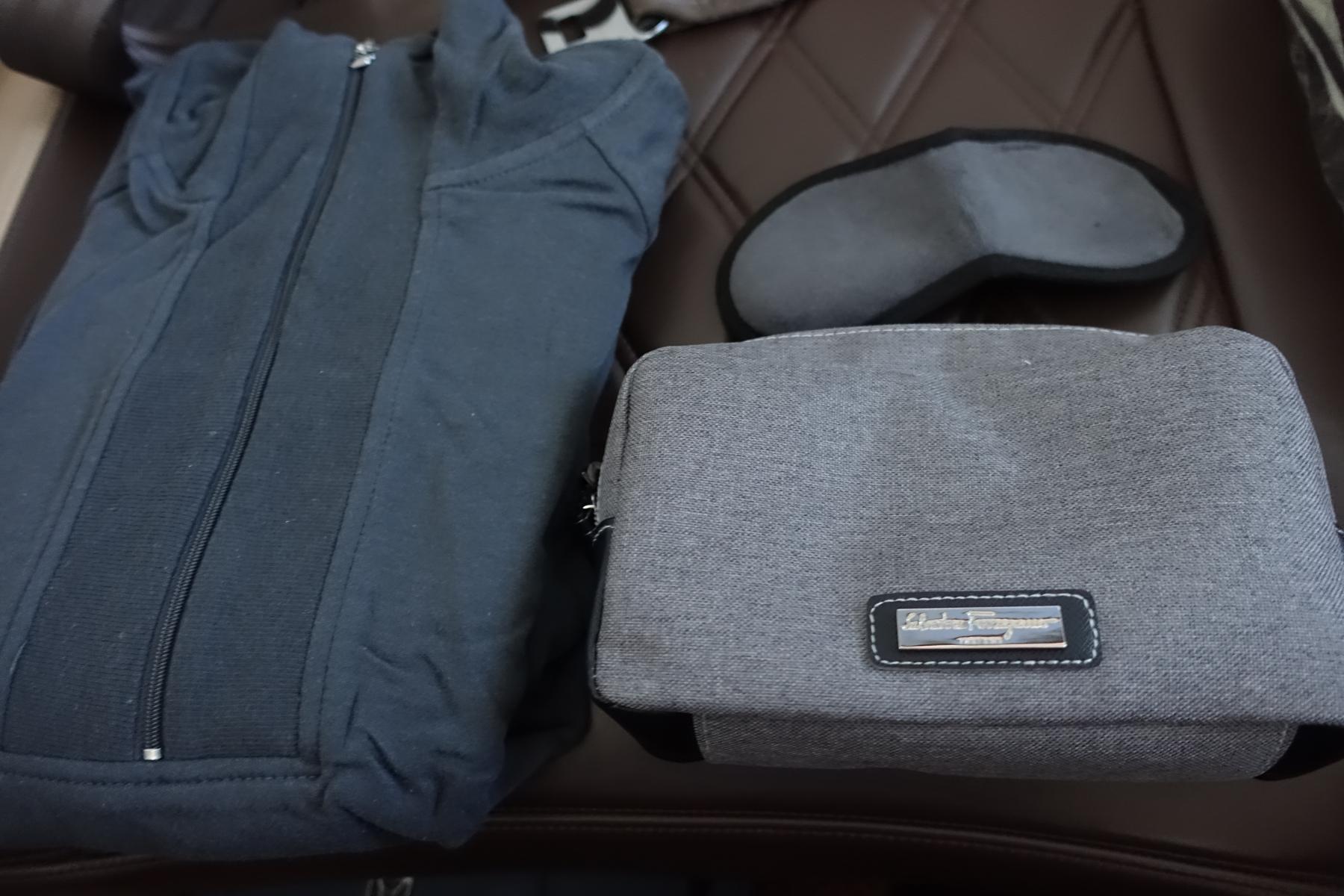 Dark grey sleepwear, eye mask, and a Salvatore Ferragamo amenity kit.