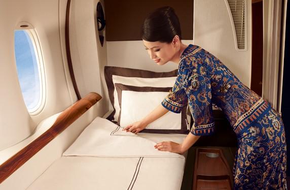 A Singapore Airlines flight attendant makes the bed in a First Class Suite.