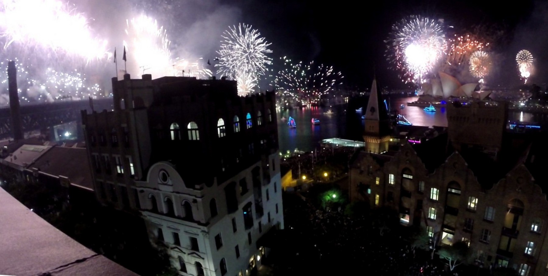 New Year's Eve fireworks explode over Sydney Harbour, illuminating the Opera House and Harbour Bridge.