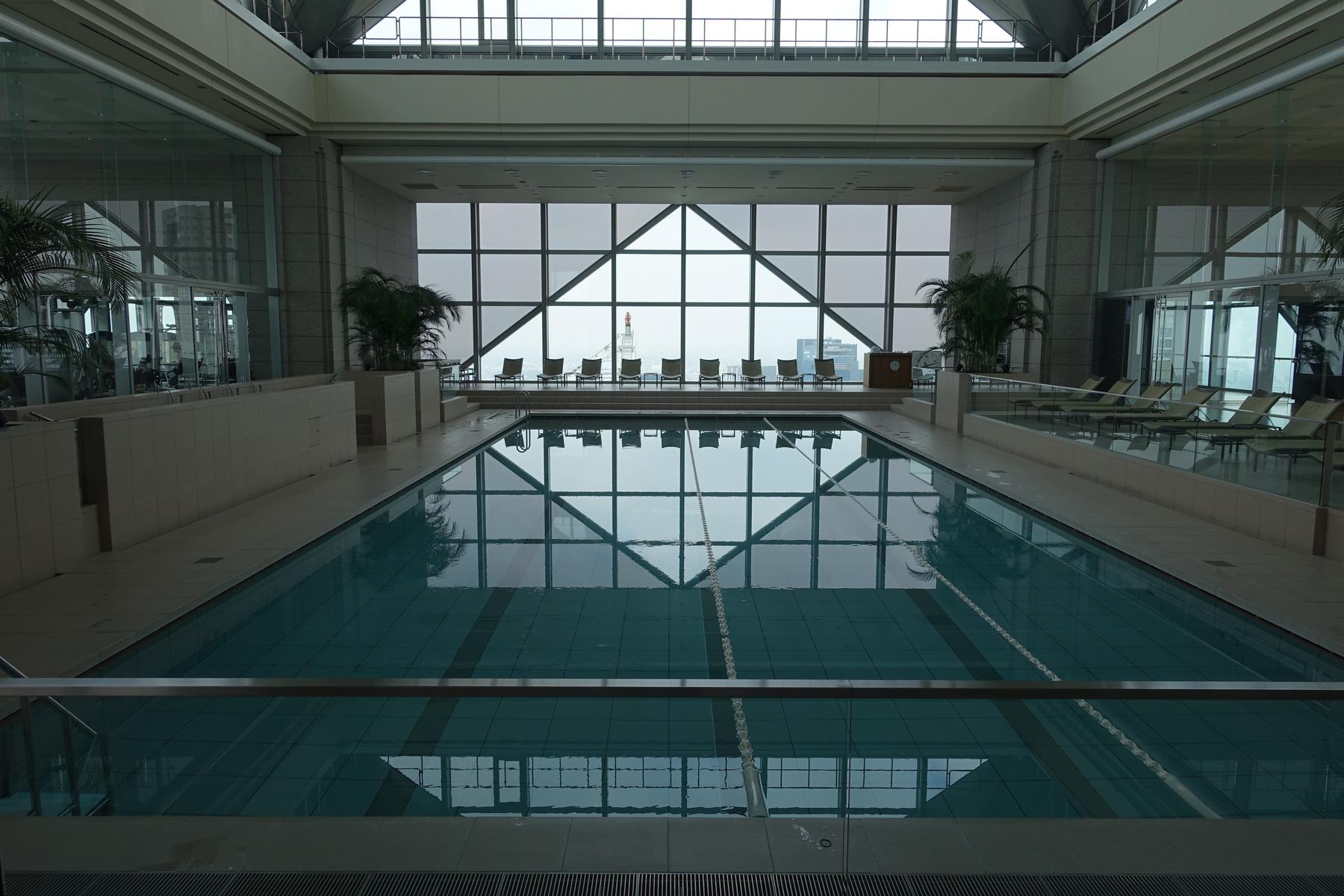 An expansive indoor swimming pool with panoramic city views at the Park Hyatt Tokyo.
