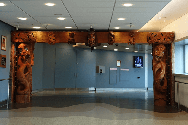 Intricate Māori carved wooden archway inside Auckland Airport.