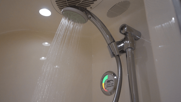 Water sprays from a showerhead in an onboard shower, next to a circular 'Remaining Time' gauge.