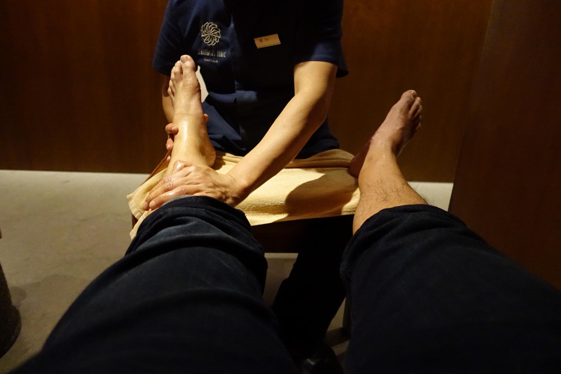 A first-person view of someone receiving a foot massage.