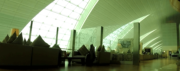 Luxurious Emirates First Class lounge with comfortable seating and a distinctive architectural ceiling.