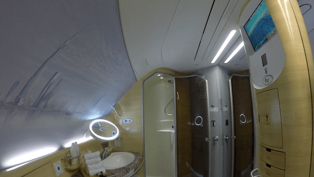 Emirates A380 First Class shower spa featuring a vanity, sink, and two shower stalls.