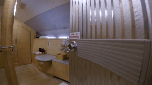 Emirates A380 First Class shower spa with wooden interior and vanity.