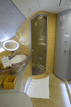 Emirates A380 First Class bathroom with a full shower and marble vanity.