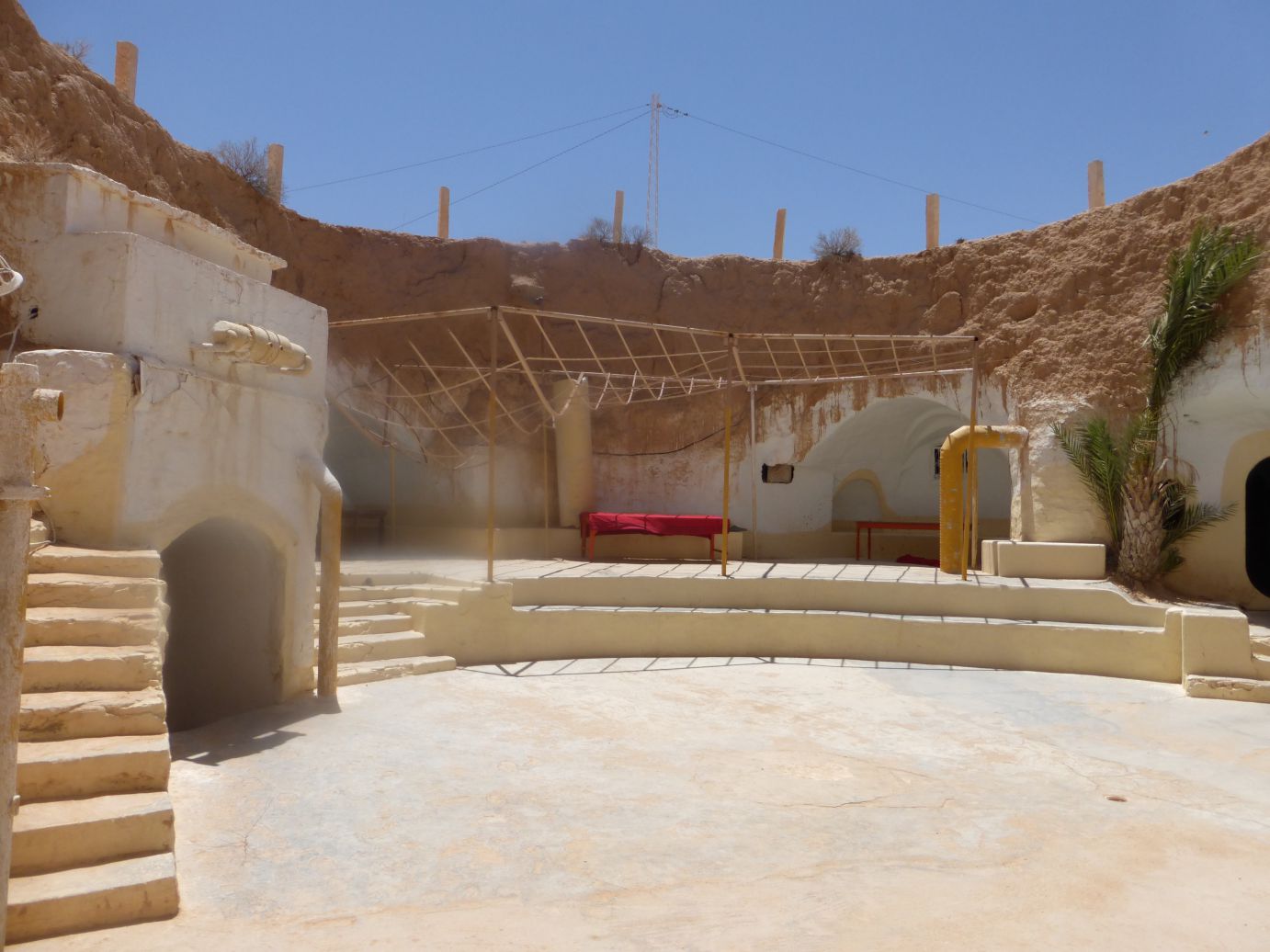 The open courtyard of Luke Skywalker's Lars Homestead set, built into sandy rock formations in Tunisia.