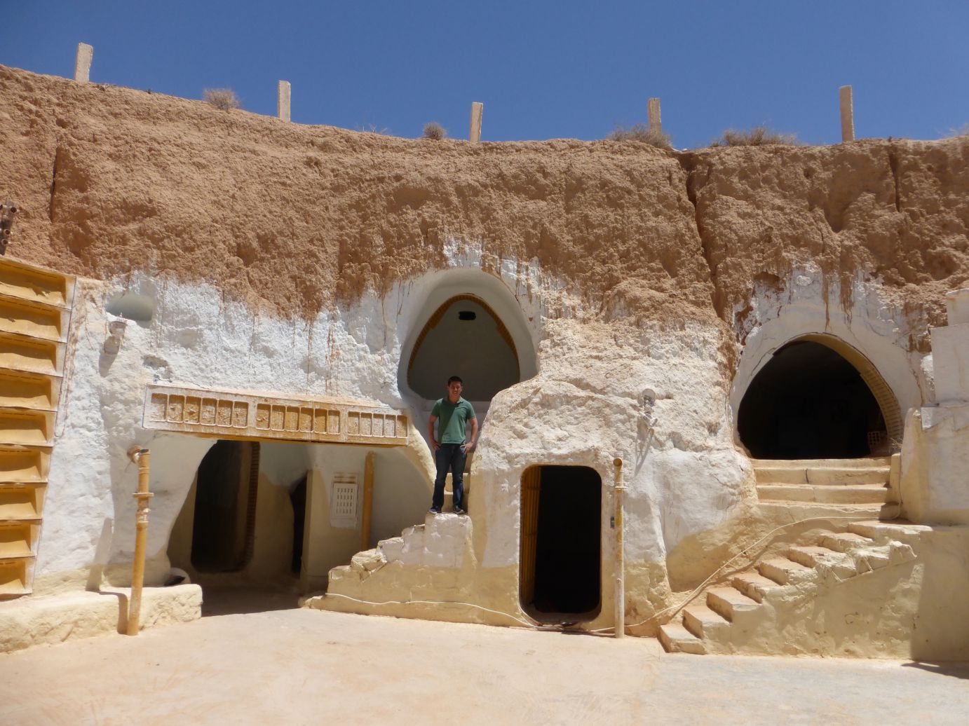 Man posing in front of original Star Wars cave dwellings in Tunisia.