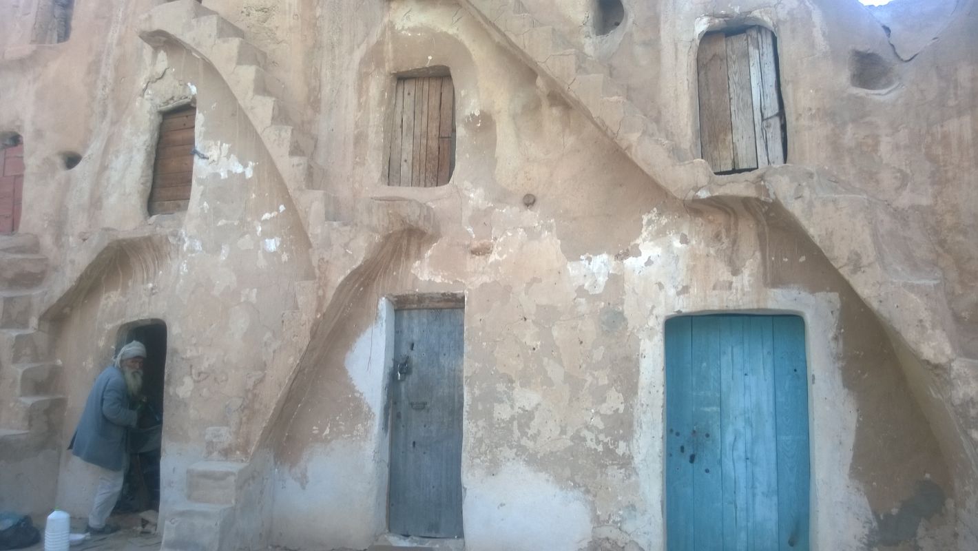 A man stands in the doorway of an original Star Wars set dwelling in Tunisia.