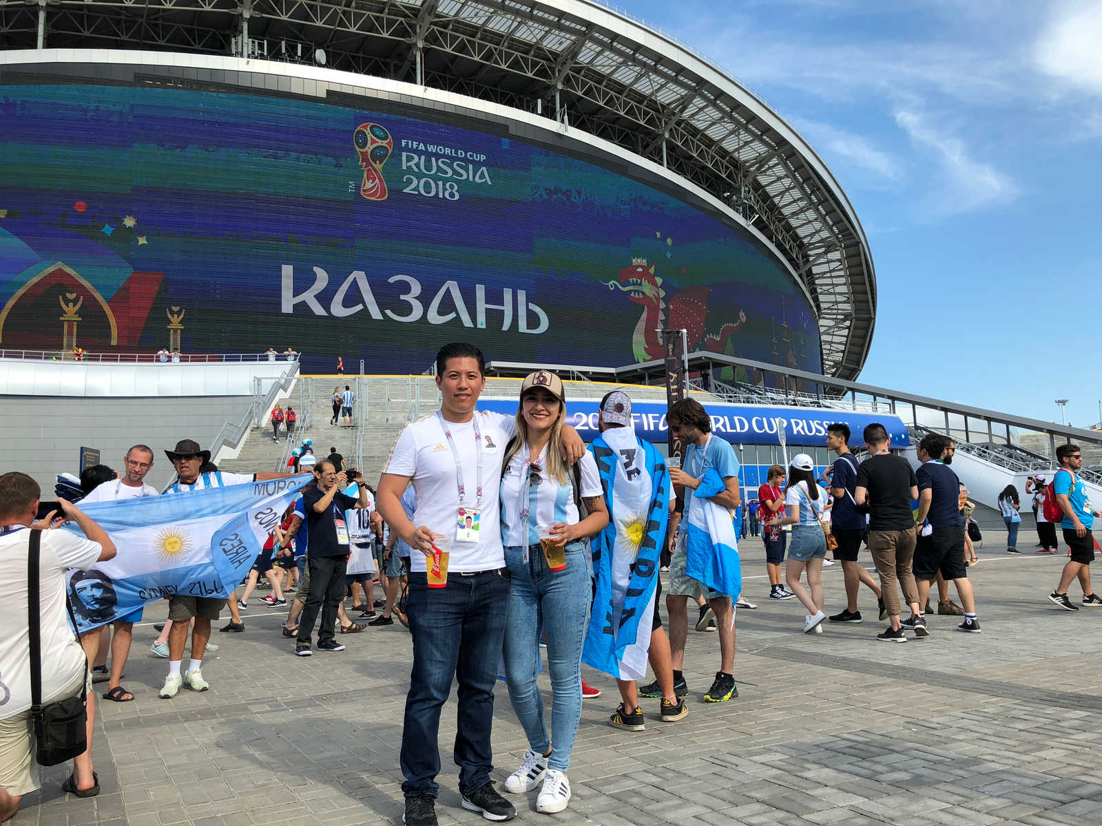 Smiling Argentina fans pose outside the Kazan Arena during the 2018 FIFA World Cup.