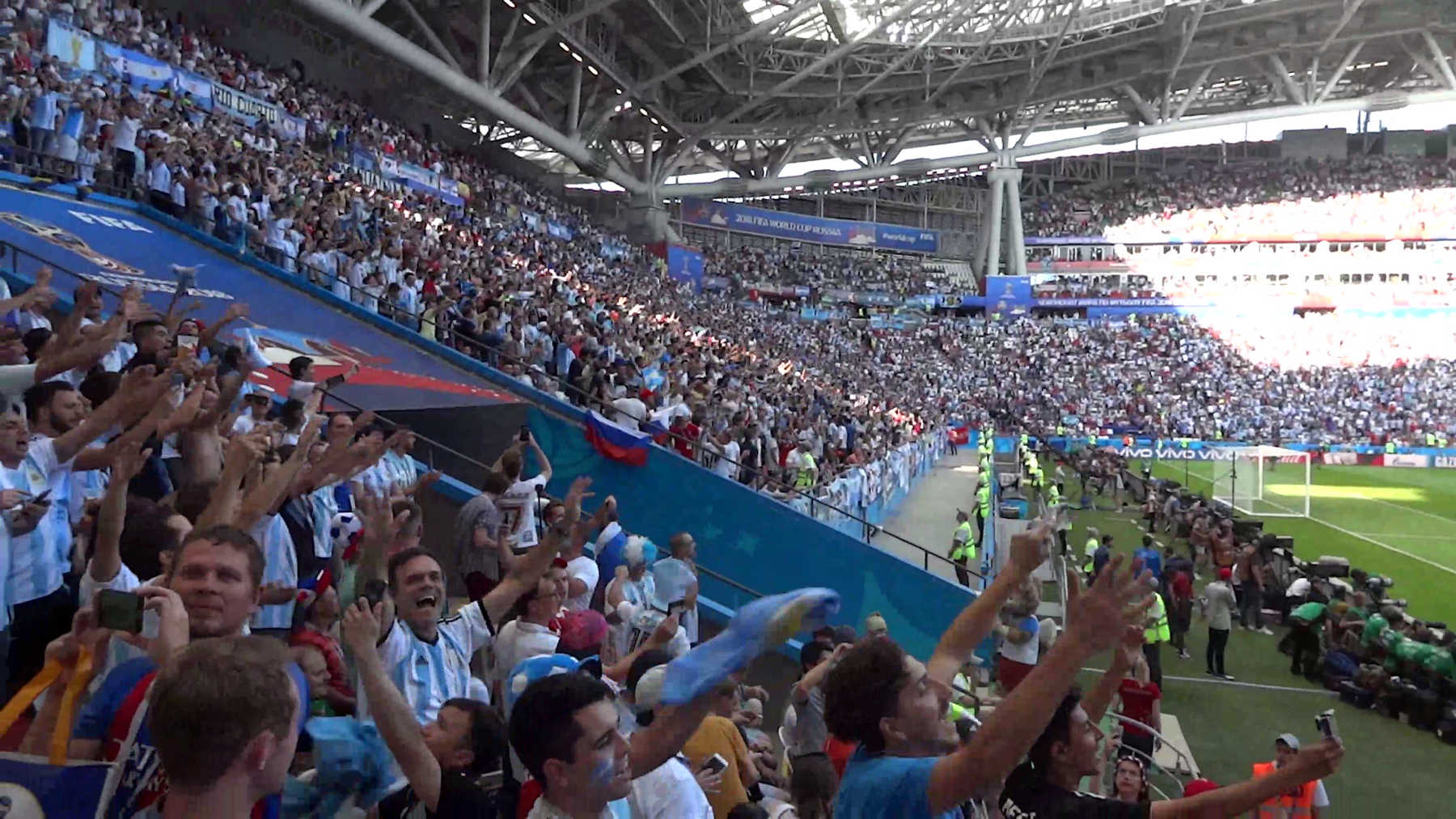 Argentine fans cheer excitedly in a crowded stadium at the 2018 World Cup.