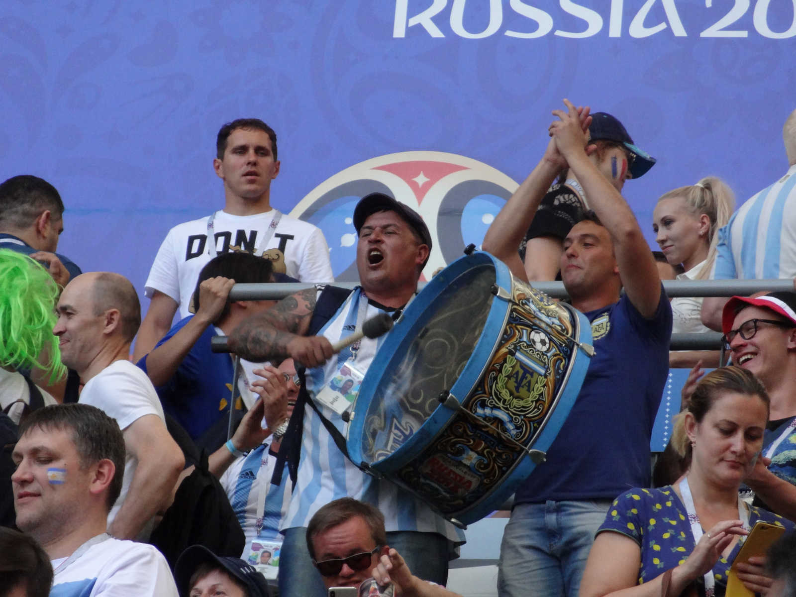 Argentinian fans cheer, with one enthusiastically playing a large drum, at the 2018 World Cup.